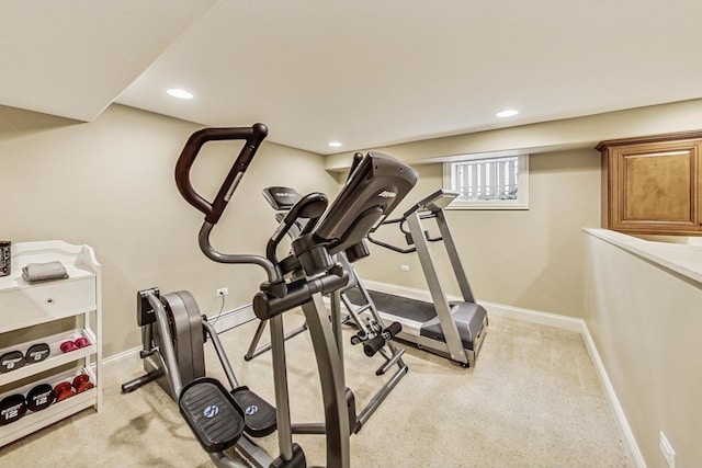 exercise area featuring light carpet, baseboards, and recessed lighting