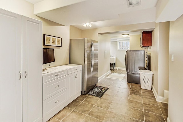 bathroom with tile patterned flooring, visible vents, and baseboards