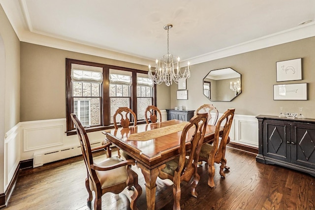 dining room with a wainscoted wall, ornamental molding, baseboard heating, and dark wood-style flooring