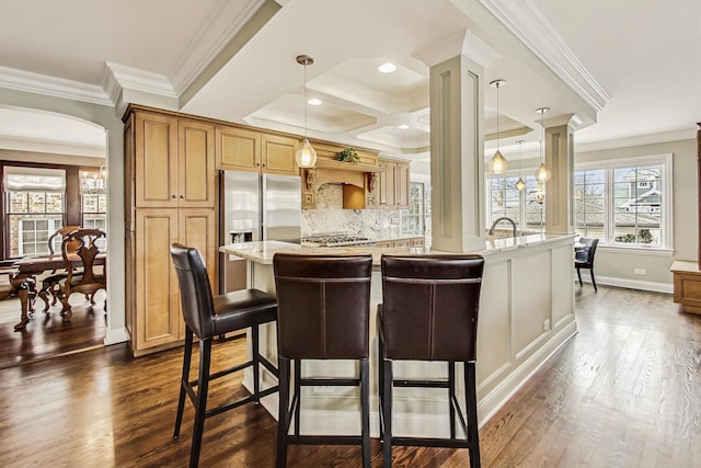 kitchen featuring hanging light fixtures, light stone countertops, dark wood-style floors, and backsplash