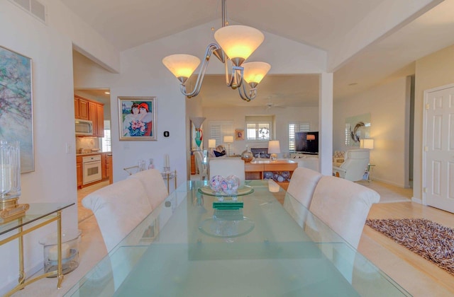 dining space with an inviting chandelier, visible vents, and vaulted ceiling