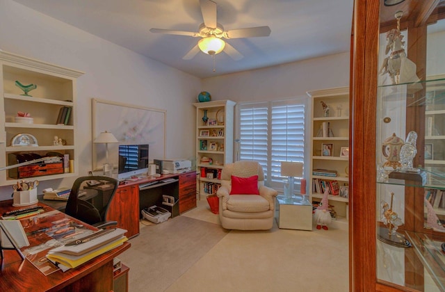 office space with carpet floors, ceiling fan, and built in features