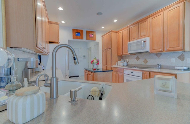 kitchen featuring white appliances, backsplash, and light brown cabinetry