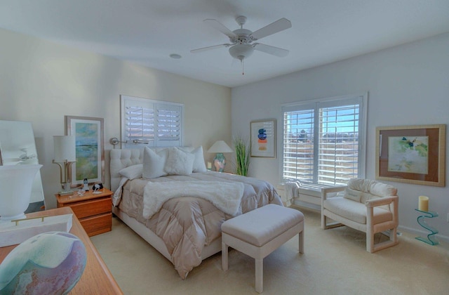 bedroom featuring light carpet and ceiling fan