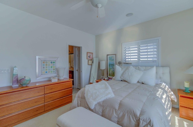 bedroom with ceiling fan and ensuite bath