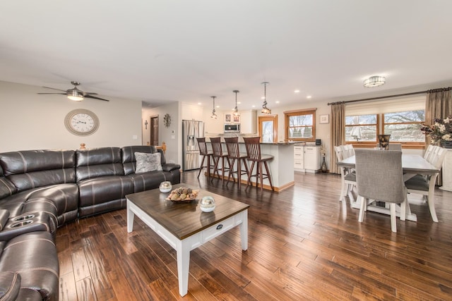 living room featuring hardwood / wood-style floors and ceiling fan