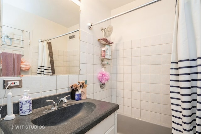 full bath featuring vanity, visible vents, tile walls, tasteful backsplash, and shower / bathtub combination with curtain