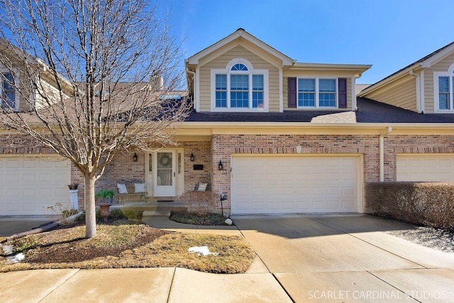 view of front of house featuring a garage, brick siding, driveway, and roof with shingles