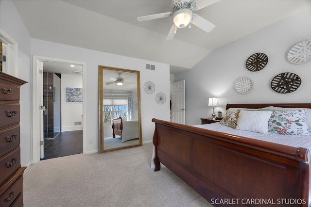 bedroom featuring light carpet, visible vents, vaulted ceiling, and ensuite bathroom