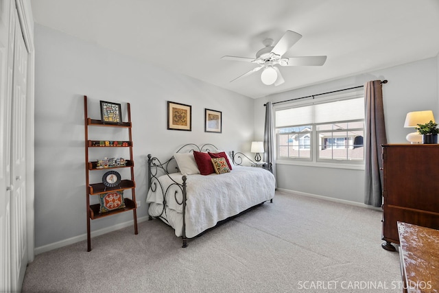 bedroom with light carpet, ceiling fan, and baseboards