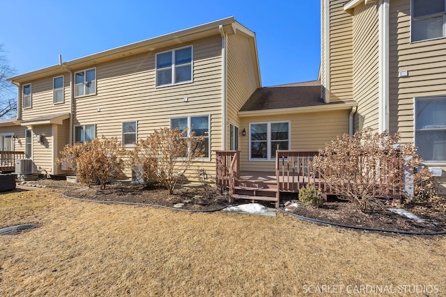 back of property featuring central air condition unit and a deck