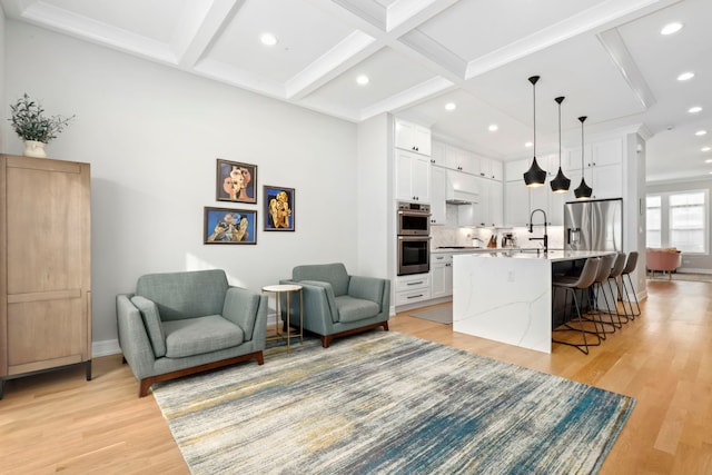 living area featuring recessed lighting, beamed ceiling, coffered ceiling, and light wood-style floors