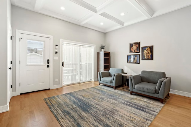 living area with light wood finished floors, beamed ceiling, coffered ceiling, and baseboards