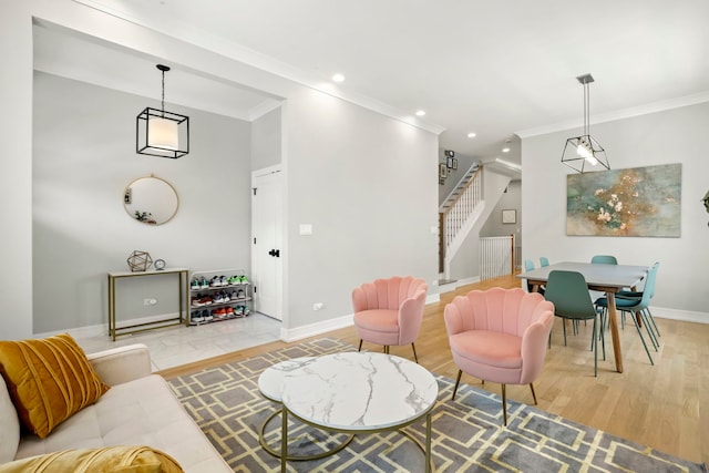 living area with light wood finished floors, baseboards, stairs, and ornamental molding