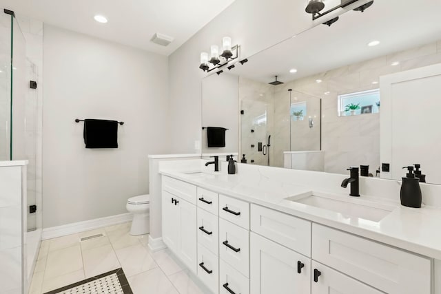 full bath featuring double vanity, a shower stall, toilet, and a sink