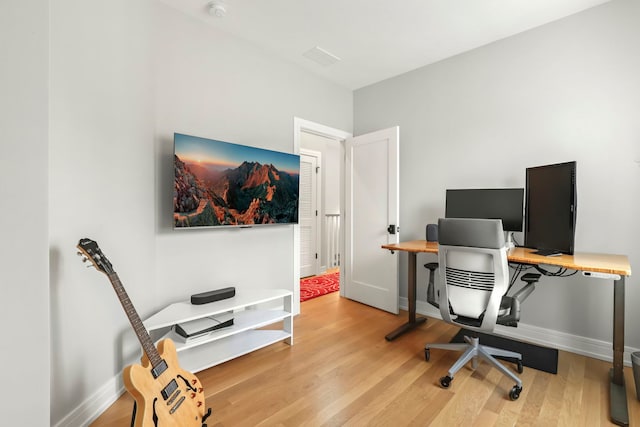 office area with light wood finished floors and baseboards