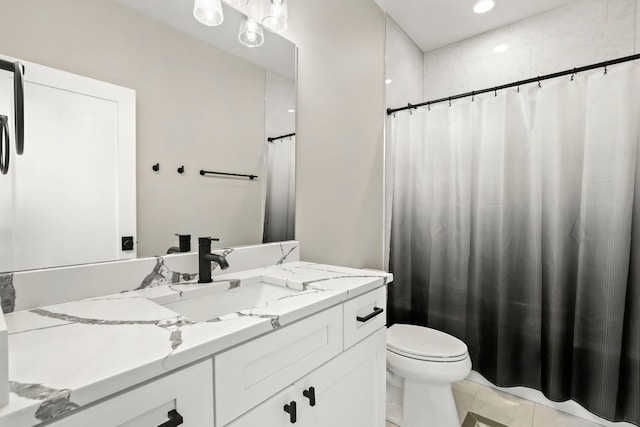 bathroom featuring toilet, a shower with shower curtain, vanity, and tile patterned floors