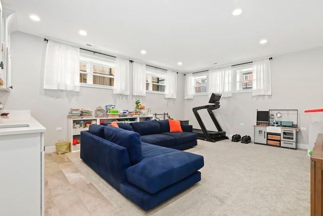 living area with baseboards, light colored carpet, and recessed lighting