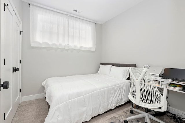 bedroom featuring light colored carpet, visible vents, and baseboards