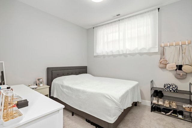 bedroom featuring light colored carpet and visible vents