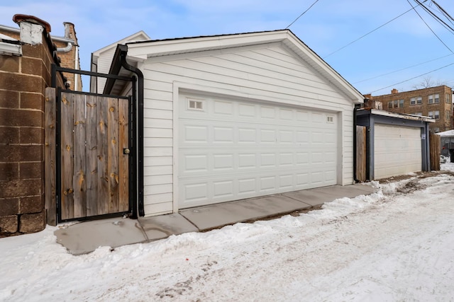 snow covered garage with a garage