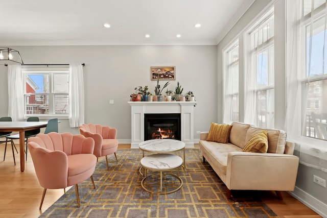 living room featuring dark wood-style floors, recessed lighting, baseboards, and a glass covered fireplace