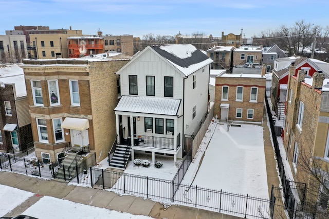 multi unit property featuring board and batten siding and a fenced front yard