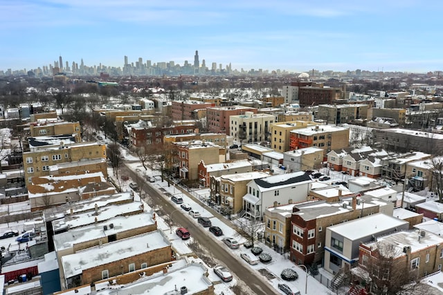 snowy aerial view featuring a view of city