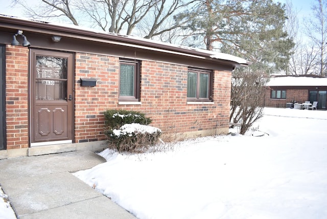 view of snow covered property entrance