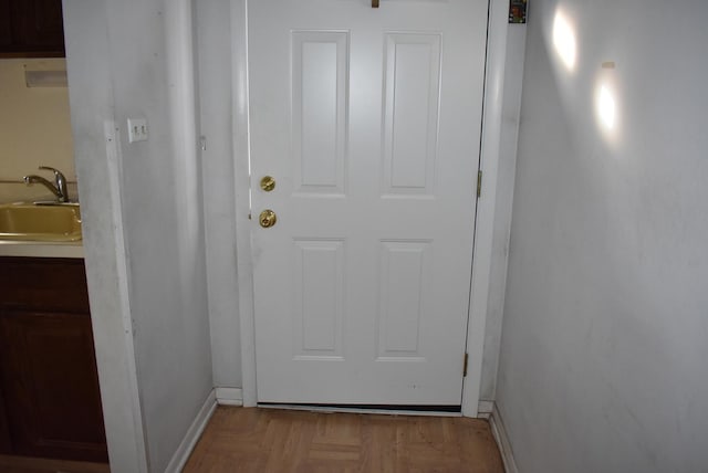 doorway to outside featuring sink