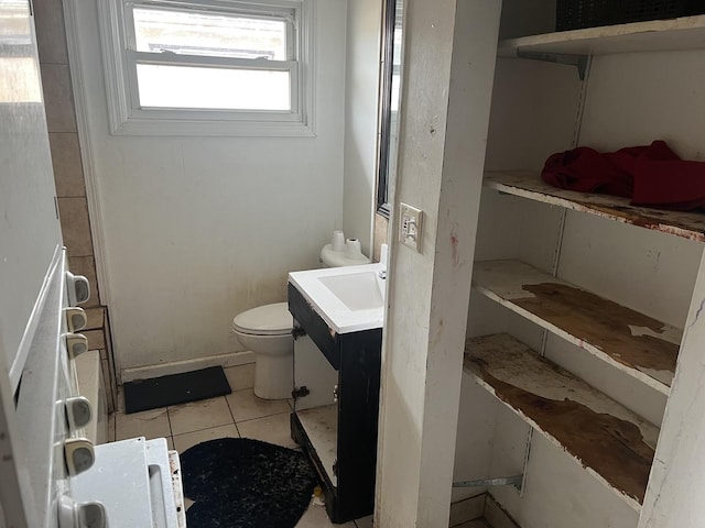 bathroom featuring tile patterned flooring, vanity, and toilet