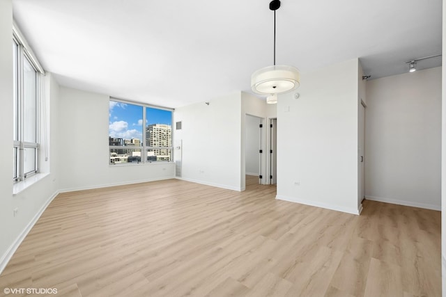 interior space featuring light wood-style flooring and baseboards