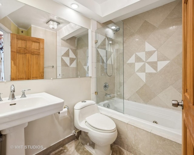 full bathroom featuring tiled shower / bath combo, sink, and toilet