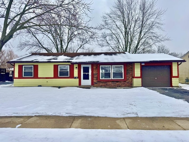 ranch-style home featuring brick siding, driveway, and an attached garage