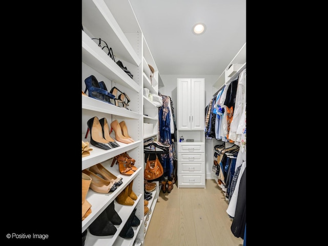 walk in closet featuring light hardwood / wood-style flooring