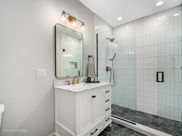 bathroom featuring vanity and a shower with shower door