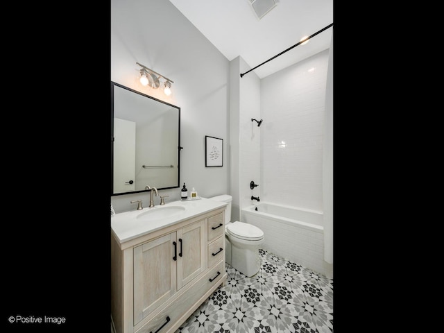 full bathroom featuring vanity, toilet, and tiled shower / bath