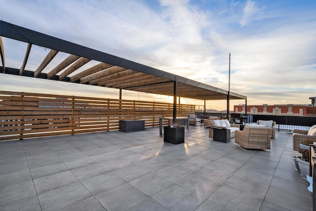 patio terrace at dusk featuring an outdoor living space