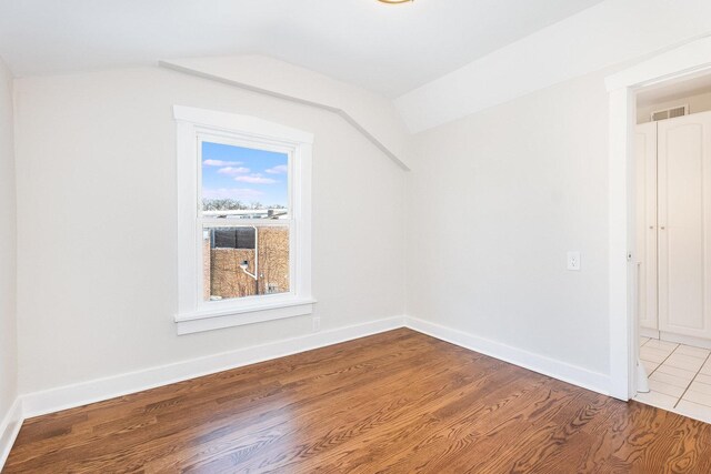 stairs with ornamental molding, a wainscoted wall, decorative columns, and wood finished floors