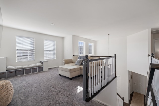 interior space featuring carpet and an upstairs landing