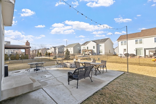 view of patio / terrace with a residential view and fence