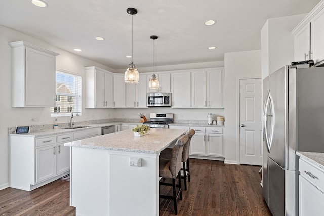 kitchen featuring stainless steel appliances, white cabinetry, a sink, and dark wood-style floors