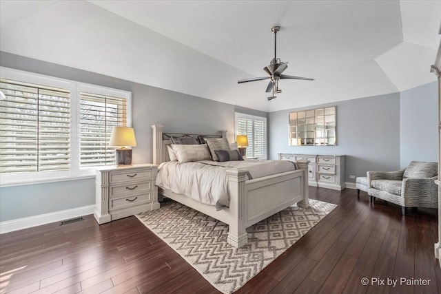 bedroom featuring lofted ceiling, dark wood-style floors, and baseboards