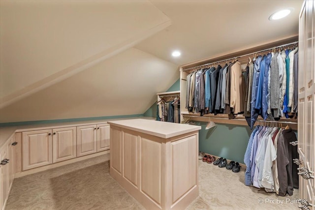 spacious closet featuring light carpet and vaulted ceiling