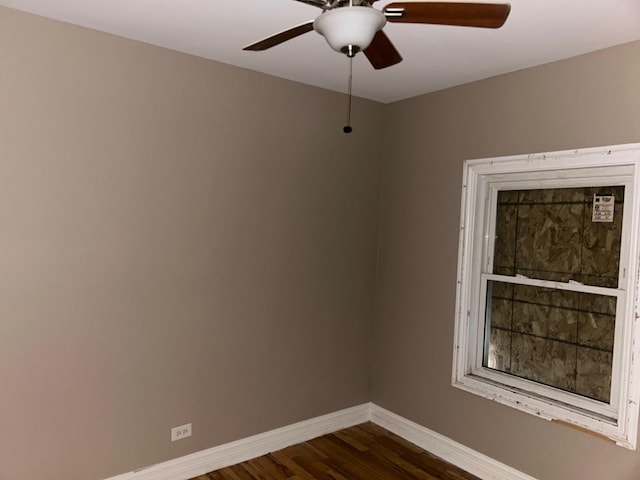 spare room with ceiling fan and dark hardwood / wood-style floors