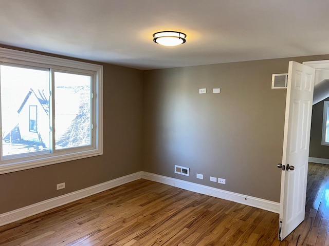 unfurnished room with wood-type flooring