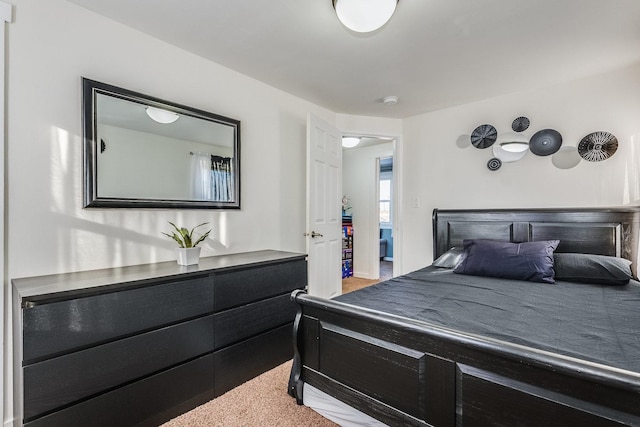 bedroom featuring light carpet