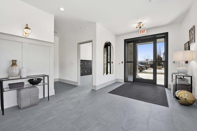 foyer featuring tile patterned flooring, baseboards, and recessed lighting