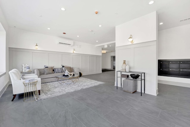 living area with recessed lighting, visible vents, a decorative wall, and a wall mounted AC