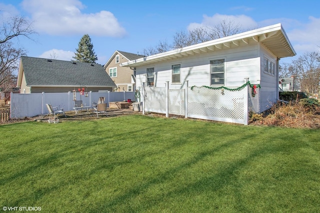 back of house with a yard and fence